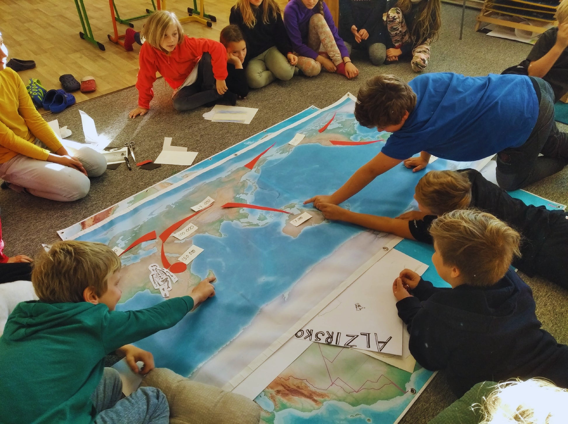 students working with Montessori world map in classroom