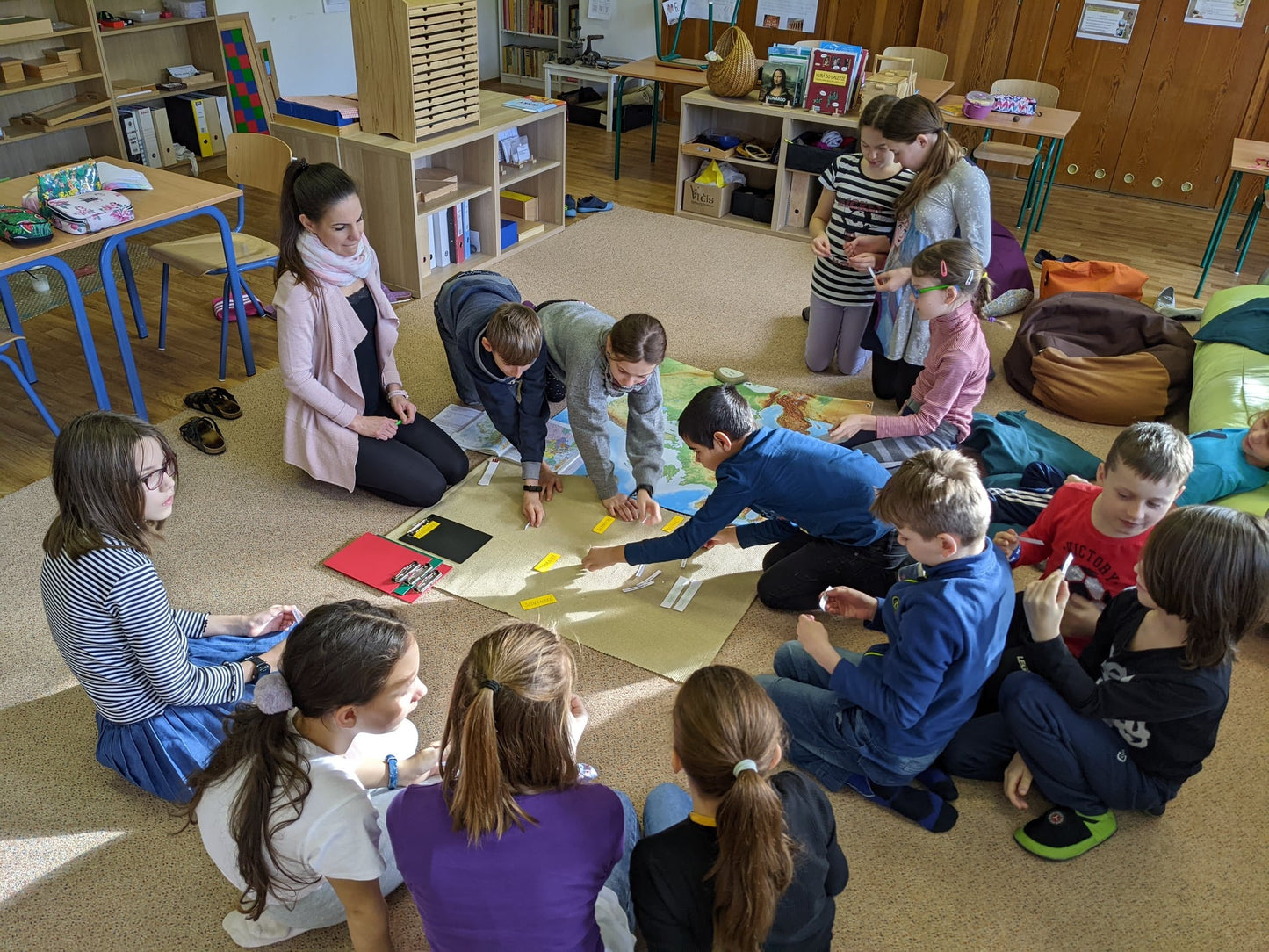 students working with a large Europe map in classroom